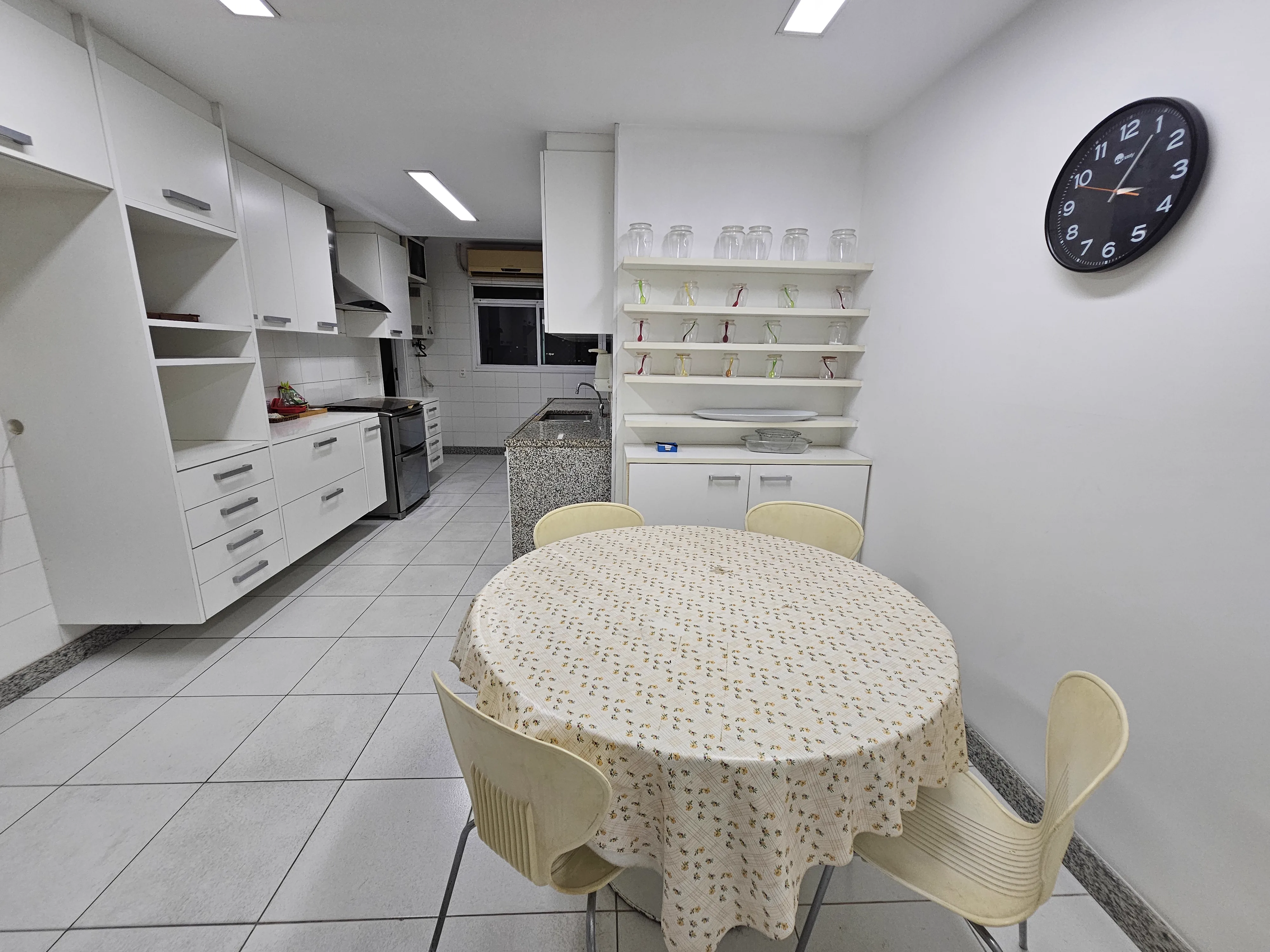 Cozinha com lustre decorativo e armários planejados